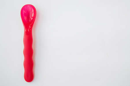 plastic spoon red white background top viewの写真素材