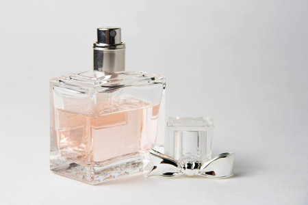 pink womens perfume bottle in a rectangular glass bottle on a white background