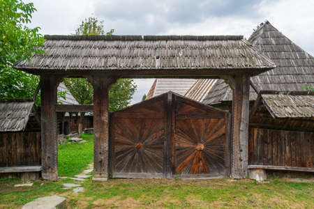 The wooden gate to the Dunca House II, Maramures Village Museum, Romaniaのeditorial素材