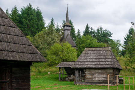 Shed for wagon, firewood, and agricultural tools close to a hangar, Maramures Village Museum, Romaniaのeditorial素材