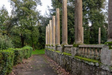 Weathered Classical Colonnade along a Path in the Wooded Park of Villa Lante, Bagnaia, Italy
