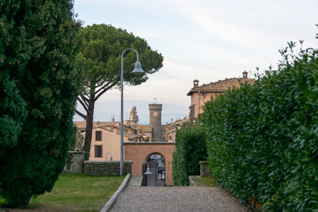 View Towards Bagnaia's Clock Tower from a Path at Villa Lante, Italyの写真素材