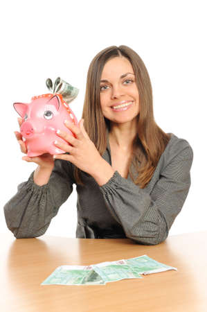  Business woman with a piggy bank isolated on whiteの写真素材