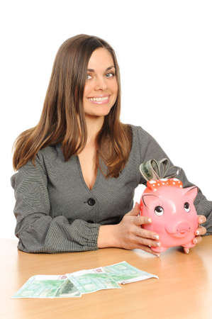  Business woman with a piggy bank isolated on whiteの写真素材