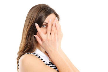 young woman  is gazing through her fingersの写真素材