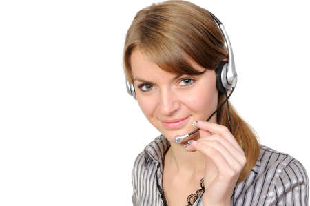 Young female customer service representative in headset, smiling  on a white backgroundの写真素材