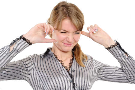   Young woman with his hands covering his ears not to hear noise.の写真素材