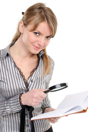 Businesswoman looking papers with magnifying glass on a white backgroundの写真素材