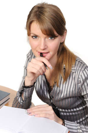 beautiful woman with long hair sits at a table with the bookの写真素材