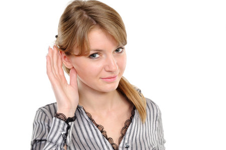 Young woman listening gossip on a white background