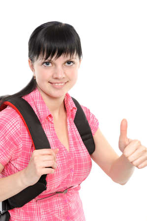 Young woman with thumbs ok; bears a backpack; isolated on a white backgroundの写真素材