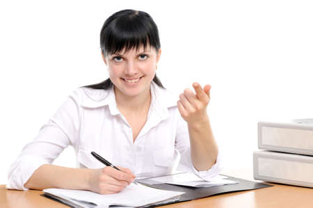 Beautiful young woman in a white shirt sits at a table with the handle in a hand
の写真素材