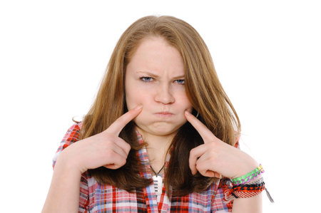 ridiculous girl inflates cheeks on the isolated background 