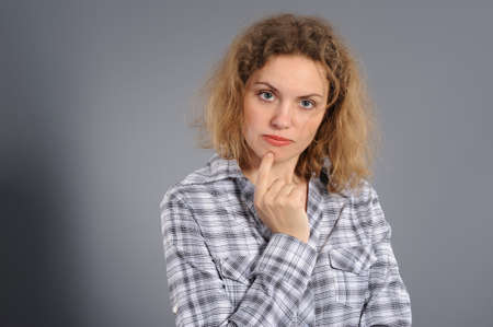 Portrait of the concentration woman , on a grey backgroundの写真素材