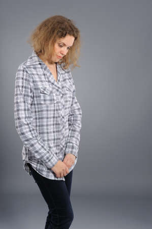 confused woman, on a grey backgroundの写真素材