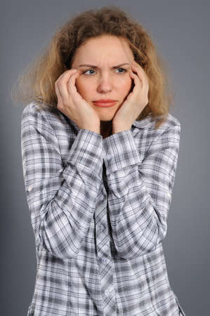 upset woman isolated  on grey background の写真素材