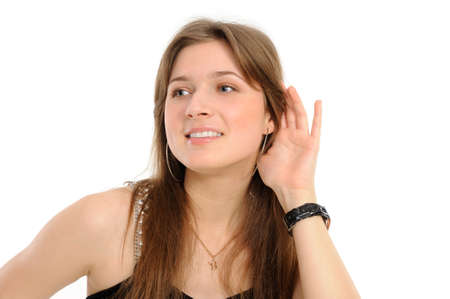 young woman listening gossip isolated on white background の写真素材