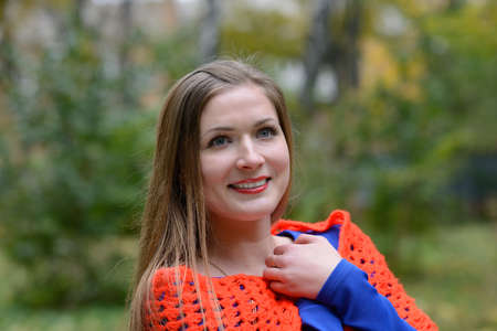 Girl wrapped in a shawl. The concept warmth and home comfort. Red lipstick.の写真素材