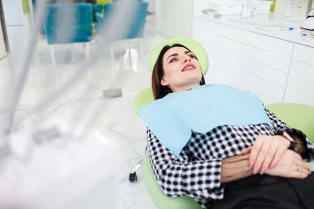 Female patient lies in the dental chair waiting for the treatment processの写真素材
