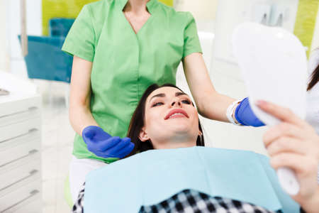 Dentist patient looks in the mirrorの写真素材