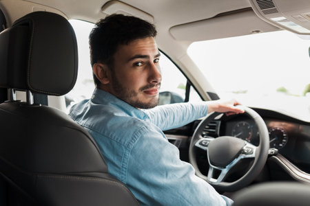 Handsome man driving a beautiful car