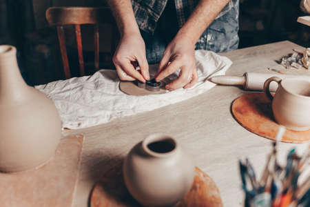 Potter makes clay decorations in the shape of heartsの写真素材