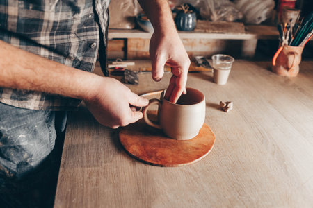 Potter works on a ceramic cup