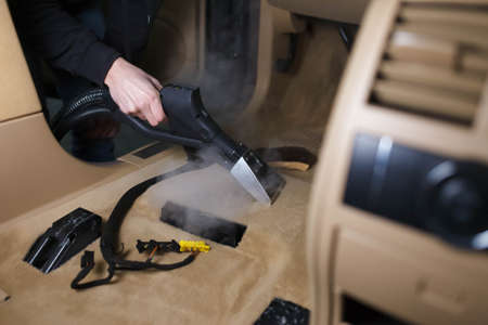 Steam cleaning a car floorの写真素材