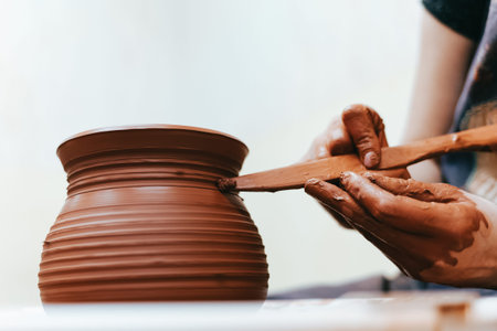 Girl works behind a pottery wheel forms a jug to perfect forms