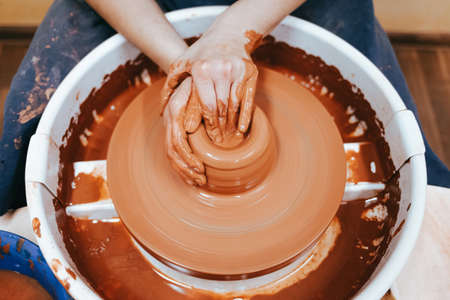Potter forms clay products into future ceramic dishes. Process of creating clay products close-upの写真素材