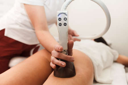 The procedure for vacuum anti-cellulite massage of the buttocks with a special deviceの写真素材