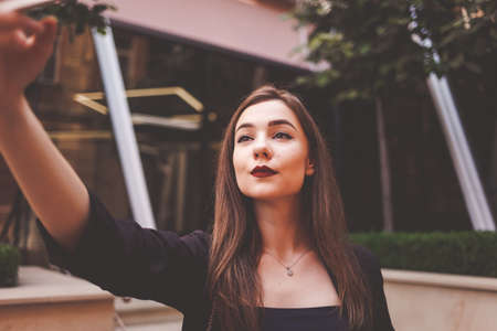 Closeup selfie portrait of a serious ladyの写真素材