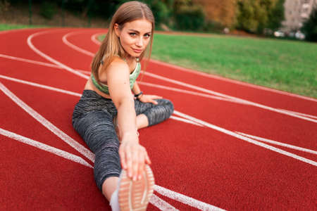 Sports girl doing stretching before runningの写真素材