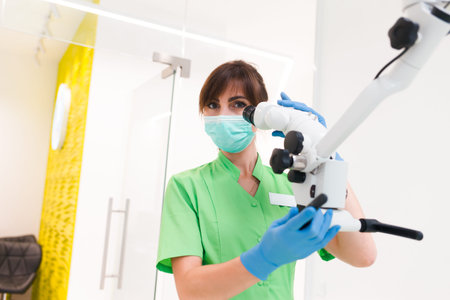 Dentist doctor using dental microscope