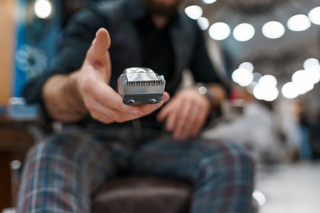 Barber master holds a hair clipper in handの写真素材