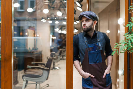 Hairdresser near the entrance to the barbershopの写真素材