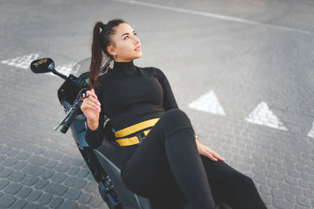 Stylish biker girl on motorcycleの写真素材