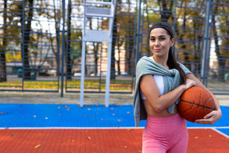 Athlete girl with a basket ball. Basketball player portraitの写真素材