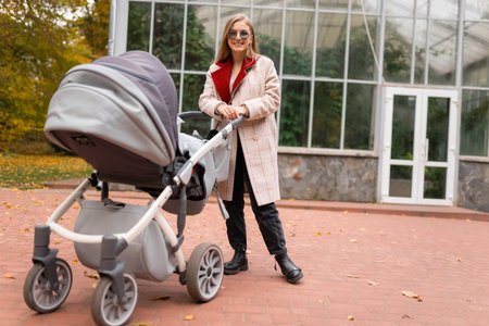 Mom with stroller walking in park