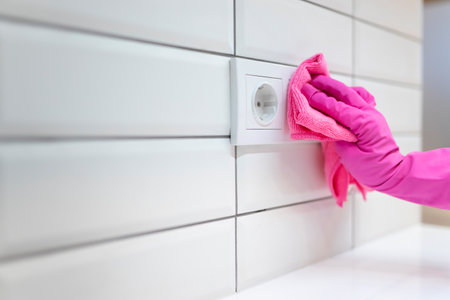 Hand in glove wipes dust on the socketの写真素材