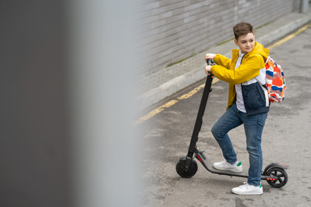 Modern teenager on electric scooter. Ecological transport conceptの写真素材