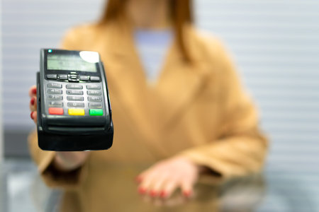 Woman gives payment terminal to client