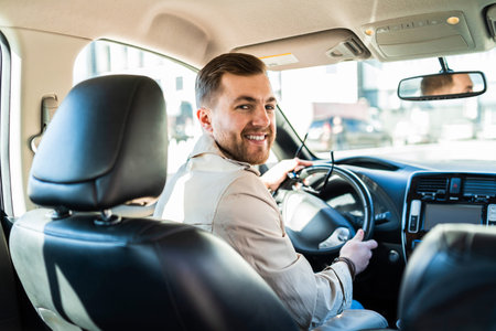 Handsome male driver looking back