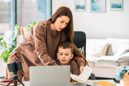 Mother helps her son with online distance education