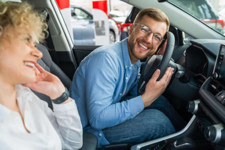 Happy couple in their new carの写真素材