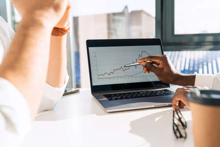 Office workers are look a growth in company income on graph in laptopの写真素材