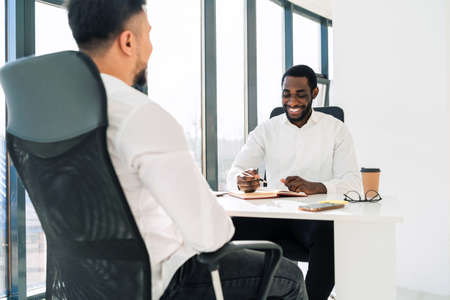 Two multiracial businessmen at meeting in the officeの写真素材