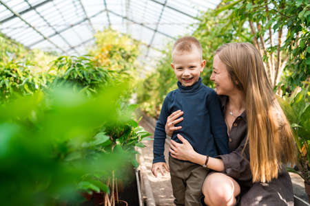 Mother and son in greenhouseの写真素材