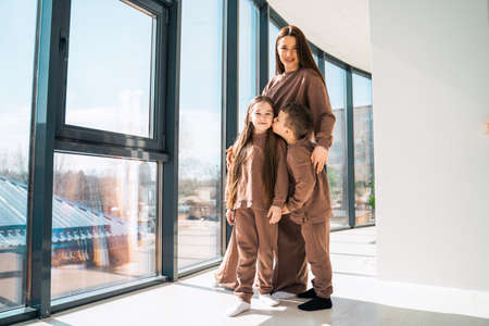 Happy mother with children in her new homeの写真素材