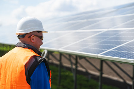 Male worker at solar panels farm